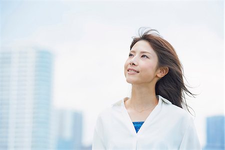 Portrait of young Japanese woman downtown Tokyo, Japan Stock Photo - Premium Royalty-Free, Code: 622-09014008
