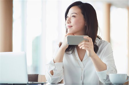 simsearch:622-08519691,k - Japanese woman with smartphone in a stylish cafe Stock Photo - Premium Royalty-Free, Code: 622-09014315