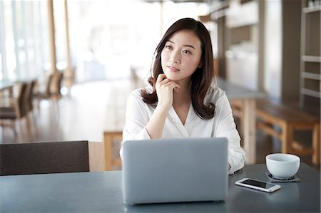 simsearch:6109-08690411,k - Japanese woman with laptop in a stylish cafe Stock Photo - Premium Royalty-Free, Code: 622-09014707