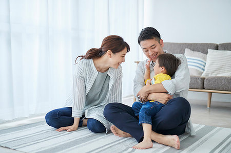 room mates - Japanese family in the living room Stock Photo - Premium Royalty-Free, Code: 622-09187524