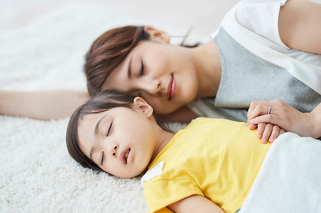 Japanese mother with sleeping kid Stock Photo - Premium Royalty-Free, Code: 622-09187556