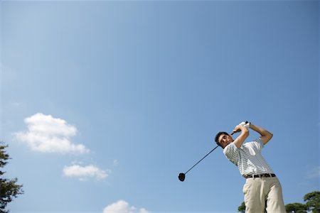 Portrait of a man making a golf swing Stock Photo - Premium Royalty-Free, Code: 622-00806960