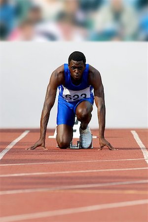Male Runner Crouched On Starting Blocks Stock Photo - Premium Royalty-Free, Code: 622-00947135