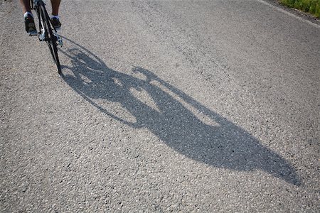 Shadow of a bicyclist casting on road Stock Photo - Premium Royalty-Free, Code: 622-02198539