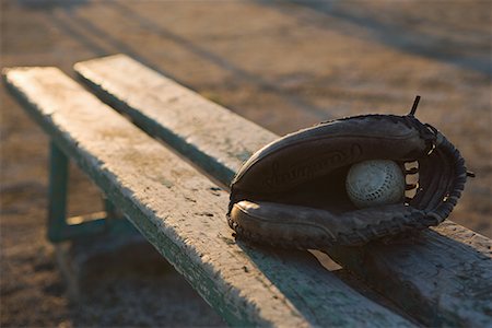 Baseball glove with ball in wooden bench Stock Photo - Premium Royalty-Free, Code: 622-02354222