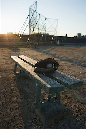 Baseball glove with ball in wooden bench Stock Photo - Premium Royalty-Free, Code: 622-02354223