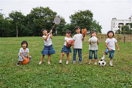 friends playing football - Children playing with sports equipments in a park Stock Photo - Premium Royalty-Free, Code: 622-02354255