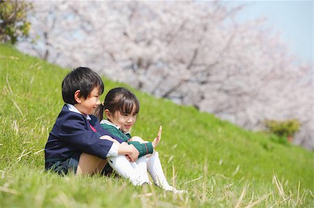 Boy and girl sitting together in a park Stock Photo - Premium Royalty-Free, Code: 622-02395698