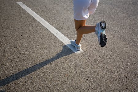 Teenage Girl Running on a Track Stock Photo - Premium Royalty-Free, Code: 622-02621574