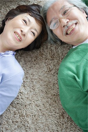 elder care - Senior couple lying head to head on carpet Stock Photo - Premium Royalty-Free, Code: 622-02759085