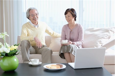 elder care - Senior couple having coffee on couch in living room Stock Photo - Premium Royalty-Free, Code: 622-02759142