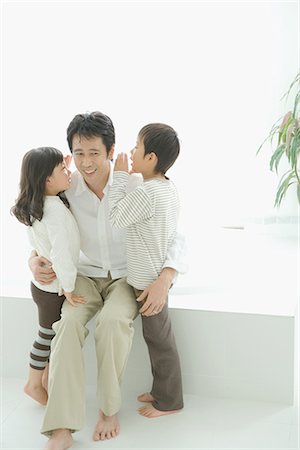 spare parts - Son and daughter whispering in their father ears Stock Photo - Premium Royalty-Free, Code: 622-02759204