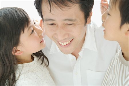 spare parts - Son and daughter whispering in their father ears Stock Photo - Premium Royalty-Free, Code: 622-02759205