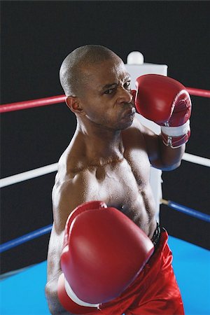 African boxer wearing red Boxing gloves ready to punch Foto de stock - Sin royalties Premium, Código: 622-02913222