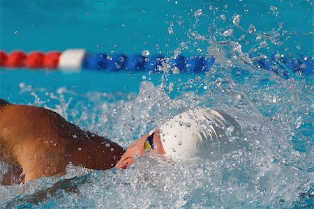 swim cap competitive - Young swimmer doing front crawl swimming stroke Stock Photo - Premium Royalty-Free, Code: 622-02913240