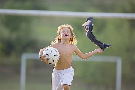 soccer player holding ball - Soccer Boy running Shirtless Stock Photo - Premium Royalty-Free, Code: 622-02913370