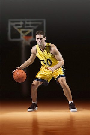 Young man playing  basketball Stock Photo - Premium Royalty-Free, Code: 622-02913430