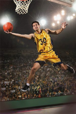 simsearch:649-07239531,k - Young man jumping and holding basketball Stock Photo - Premium Royalty-Free, Code: 622-02913444