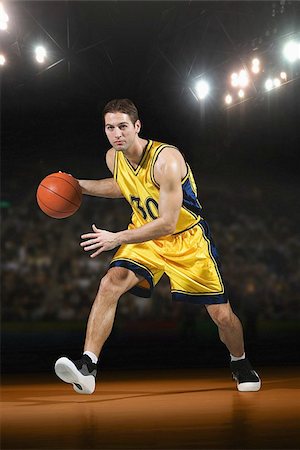 Young man playing with basketball Stock Photo - Premium Royalty-Free, Code: 622-02913449