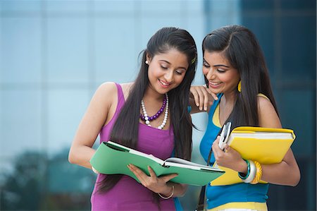 University students reading a book in university campus Stock Photo - Premium Royalty-Free, Code: 630-06724587