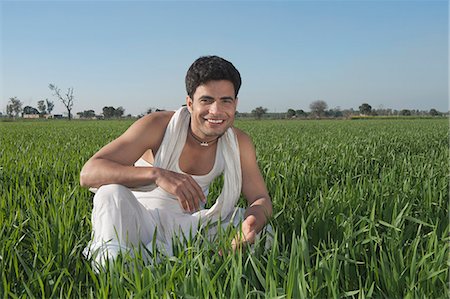 Farmer crouching in the field and smiling, Sonipat, Haryana, India Stock Photo - Premium Royalty-Free, Code: 630-06724684