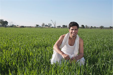 farmer asia - Farmer crouching in the field and smiling, Sonipat, Haryana, India Stock Photo - Premium Royalty-Free, Code: 630-06724682