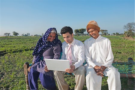 farmer asia - Businessman sitting in the field near his parents and using a laptop, Sonipat, Haryana, India Stock Photo - Premium Royalty-Free, Code: 630-06724693