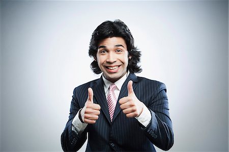 showing - Happy businessman showing thumbs up sign Stock Photo - Premium Royalty-Free, Code: 630-06724724