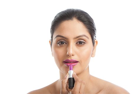simsearch:693-06323962,k - Woman applying pink lipstick Stock Photo - Premium Royalty-Free, Code: 630-06724794