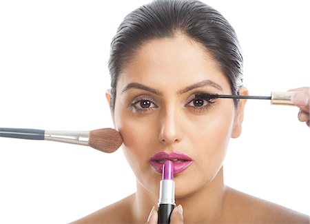 simsearch:693-06323962,k - Woman applying assorted make up Stock Photo - Premium Royalty-Free, Code: 630-06724792