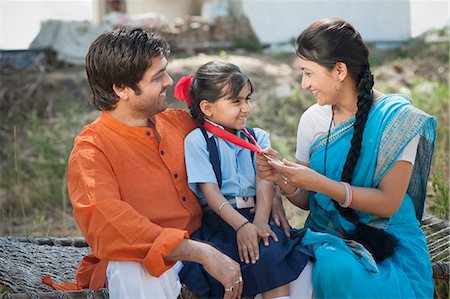 farmers family of three - Rural couple enjoying the achievement of their daughter, Sohna, Haryana, India Stock Photo - Premium Royalty-Free, Code: 630-06724964