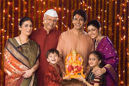 simsearch:630-01296751,k - Portrait of a family holding an idol of lord Ganesha Stock Photo - Premium Royalty-Free, Code: 630-06721949