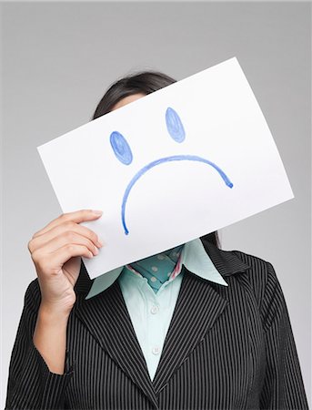 sad black people - Businesswoman holding a sad face in front of her face Stock Photo - Premium Royalty-Free, Code: 630-06721985