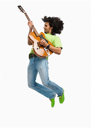 fashion men shoes - Man jumping in the air while playing a guitar Stock Photo - Premium Royalty-Free, Code: 630-06722259