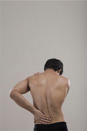 shirtless teen boy - Man suffering from backache Stock Photo - Premium Royalty-Free, Code: 630-06722675