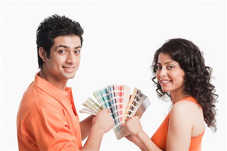 Couple choosing color from color swatches for their house Stock Photo - Premium Royalty-Free, Code: 630-06722728
