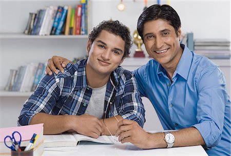 father son study - Portrait of a man with his arm around his son Stock Photo - Premium Royalty-Free, Code: 630-06722804