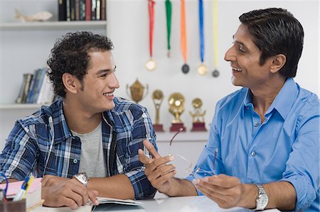 father son study - Man talking to his son and smiling Stock Photo - Premium Royalty-Free, Code: 630-06722805