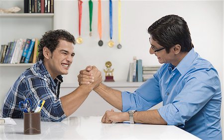 Man and his father arm wrestling Stock Photo - Premium Royalty-Free, Code: 630-06722816