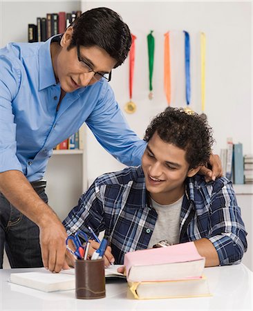 father son study - Man helping his son in study Stock Photo - Premium Royalty-Free, Code: 630-06722817