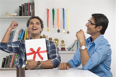 Man hugging a laptop and celebrating Stock Photo - Premium Royalty-Free, Code: 630-06722812