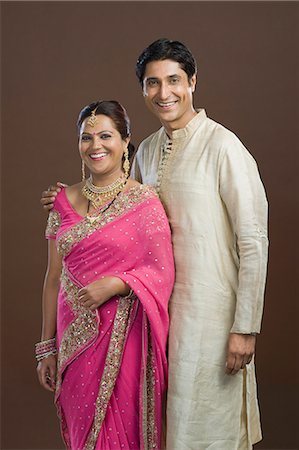 saree couples - Man standing with his arm around his wife and smiling Stock Photo - Premium Royalty-Free, Code: 630-06722865