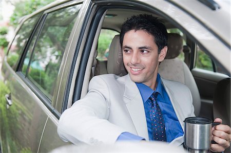 formal wear and car - Businessman drinking coffee while driving a car Stock Photo - Premium Royalty-Free, Code: 630-06723035