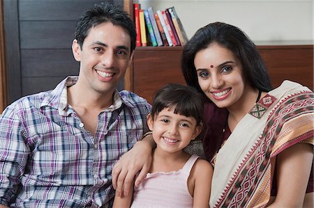 saree couples - Portrait of a couple smiling with their daughter Stock Photo - Premium Royalty-Free, Code: 630-06723132