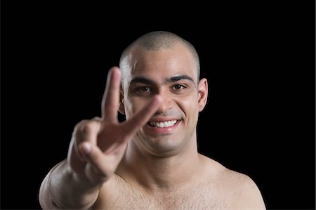 peace sign - Portrait of a man making a peace sign Stock Photo - Premium Royalty-Free, Code: 630-06723153