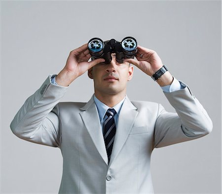 simsearch:630-06724175,k - Businessman looking through binoculars Stock Photo - Premium Royalty-Free, Code: 630-06723229