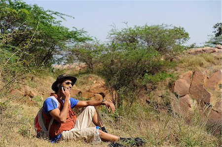 Hiker talking on a mobile phone Stock Photo - Premium Royalty-Free, Code: 630-06723487