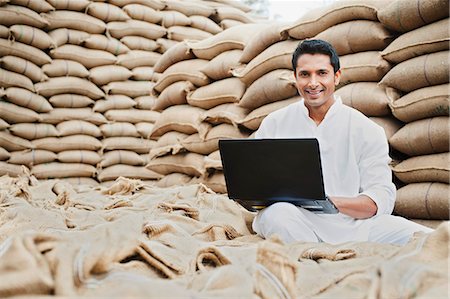 street market india - Man using a laptop in a grains market, Anaj Mandi, Sohna, Gurgaon, Haryana, India Stock Photo - Premium Royalty-Free, Code: 630-07071187