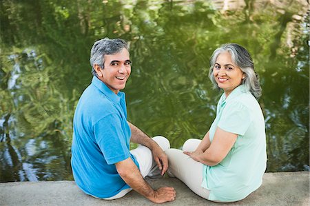 Mature couple sitting in a park at the lakeside and smiling, Lodi Gardens, New Delhi, India Stock Photo - Premium Royalty-Free, Code: 630-07071254