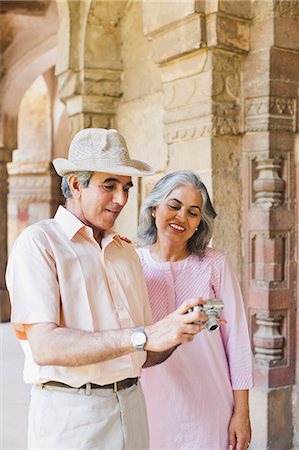 Mature couple looking photos on a digital camera, Lodi Gardens, New Delhi, India Stock Photo - Premium Royalty-Free, Code: 630-07071277